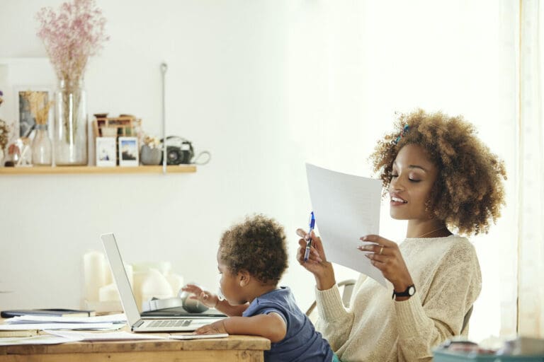 Working mom with small child in her lap