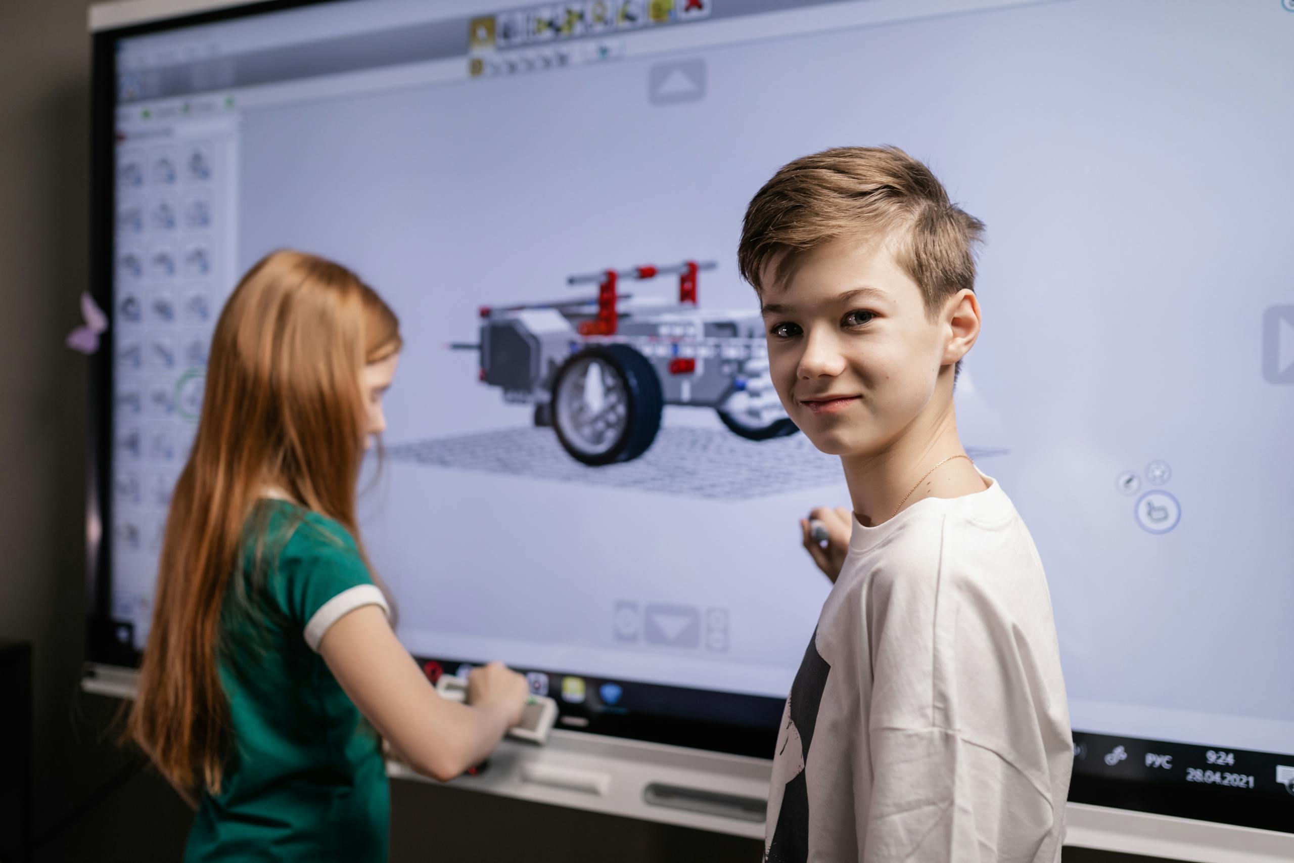 Kids interacting with a touchscreen, embracing technology education.